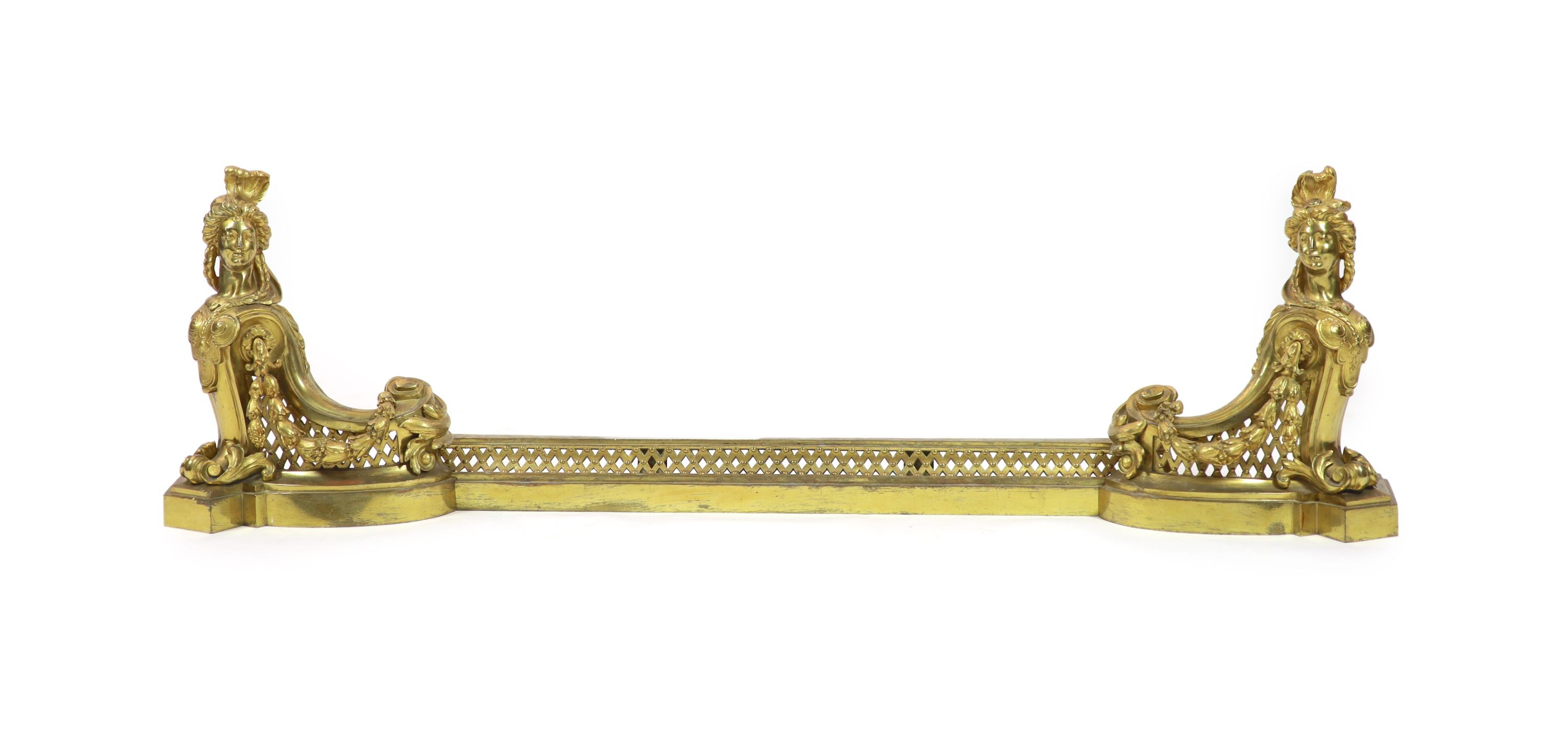 A pair of 19th century ormolu andirons Each 38cm high, 33cm wide. The kerb uniting them 86cm long.